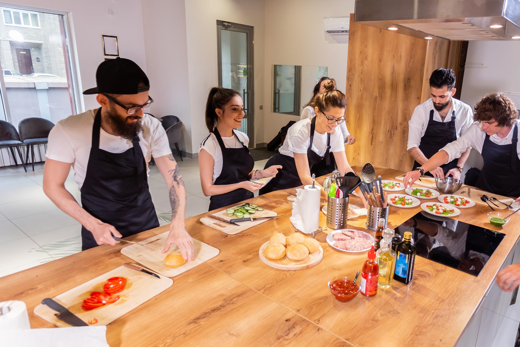 Workshop kitchen with chefs preparing ingredients