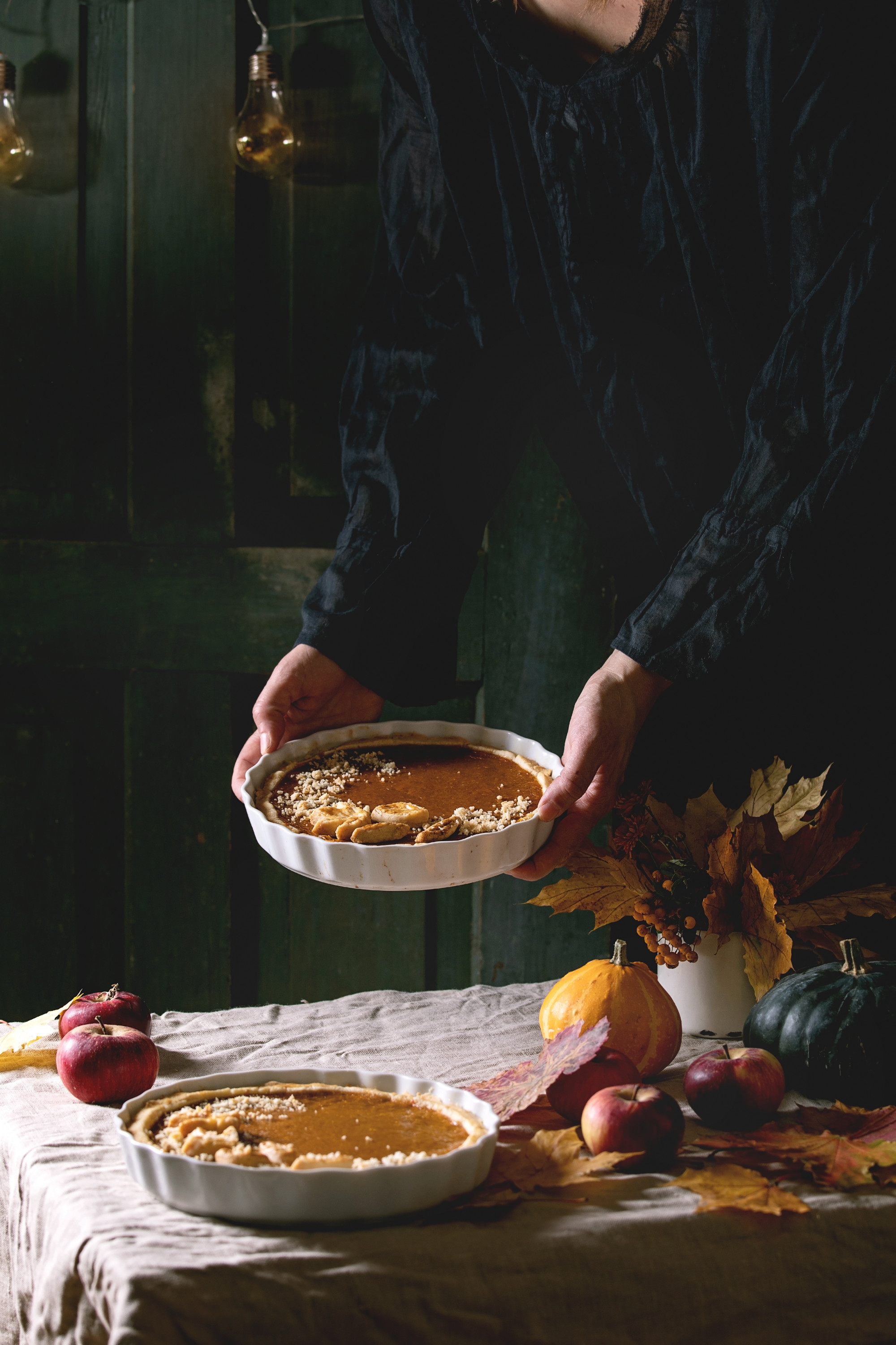 Chef arranging plated seasonal dish on wooden table